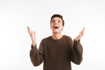 Portrait of a happy young man in sweater celebrating