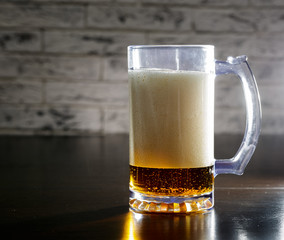 Mug with beer on the table.