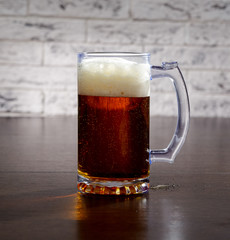 Mug with beer on the table.