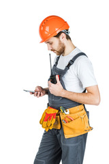 The man builder records something in the phone. Repair and construction. Isolated over white background.
