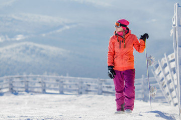 Snowboarding. Young woman holds snowboard. Copy space