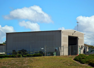 Fototapeta na wymiar Warehouse Hangar with doors open on a sunny day