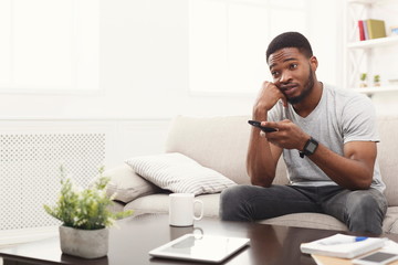 Young man watching tv at home