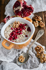 Healthy and healthy Breakfast: muesli, pomegranate, nuts. The concept of healthy eating.