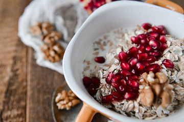 Healthy and healthy Breakfast: muesli, pomegranate, nuts. The concept of healthy eating.