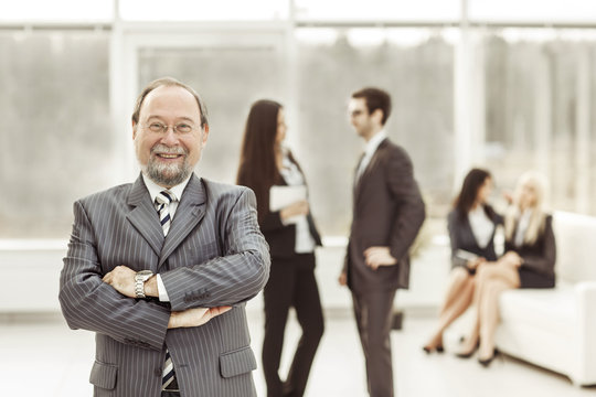 Portrait Of The General Counsel Of The Company On The Background Of Business Team In Office