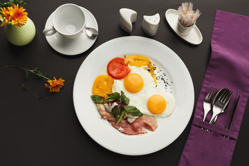Restaurant breakfast with bacon and fried eggs