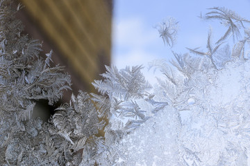 Beautiful  ice pattern on window in winter. Frosty winter pattern at  glass.