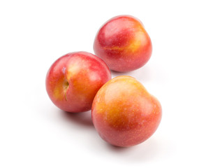 Fototapeta na wymiar Three plums red orange isolated on white background.