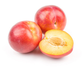 Plums red orange two whole one half isolated on white background fresh and glossy.