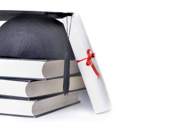Graduate rolled up in a red ribbon and a black hat on pile of book on white background