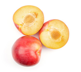Naklejka na ściany i meble Plums red orange top view isolated on white background one whole one cut in two section halves.