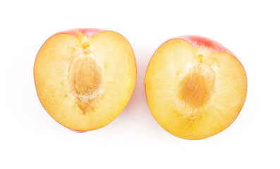Plums red orange two sliced halves top view isolated on white background.