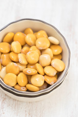 salted lupins in bowl on wooden background