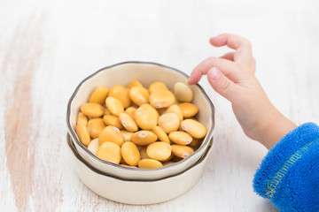 salted lupins in bowl on wooden background