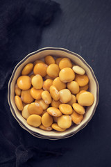 salted lupins in bowl on wooden background