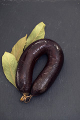 blood sausage morcela on black ceramic background