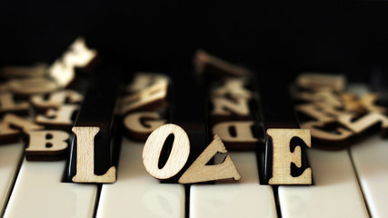 Piano keys closeup with the letters love and the heart.