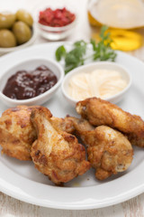 fried chicken with sauces on white plate