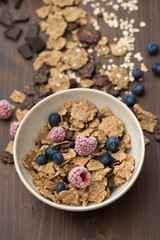 flakes with berries in brown bowl