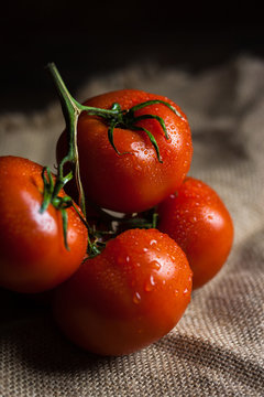 fresh tomato on wooden table and linnen centrepiese ,Image for nutrition and vegetarian food concept.