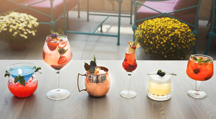 Variety of alcohol cocktails on gray table
