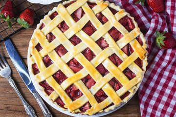 The strawberry pie in the wooden background