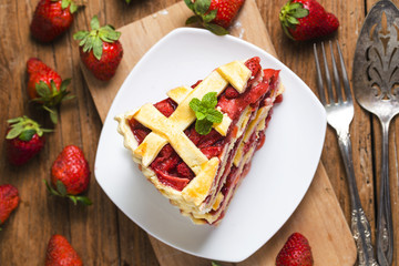 The strawberry pie in the wooden background