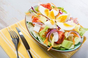 plate of vegetable salad on yellow towel
