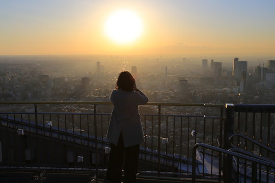 Office Lady Watch The Sunset On The Top Of Skyscraper In Tokyo