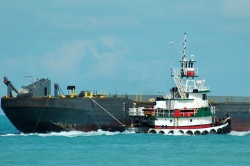 Tug boat towing a bard