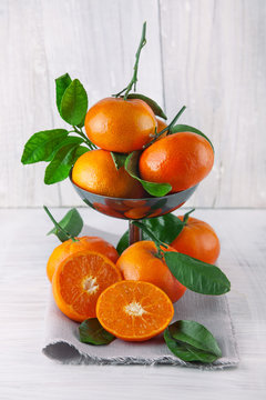 fresh ripe tangerines, rustic food photography on white wood plate kitchen table can be used as background