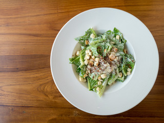 Caesar salad on wood table