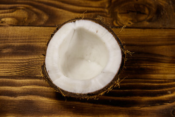 Fresh ripe coconut on rustic wooden table