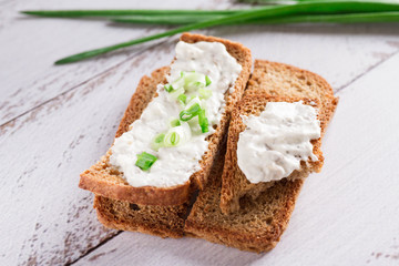 Rye crispbread with soft cheese and fresh herbs. Dietary vegetarian sandwich.Crispy dietary fitness bread.  Food for weight loss