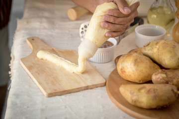 Mashed potatoes in a plate on a wooden table