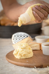 Mashed potatoes in a plate on a wooden table