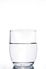 Glass with water on white background
