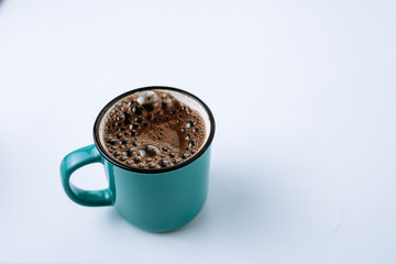 Cup of black coffee in enamel mug. Copy space.
