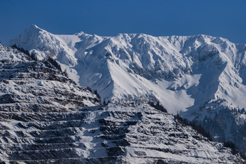 Fototapeta premium Close up of the layered mine at Eisenerz with majestic snow capped peaks in the background