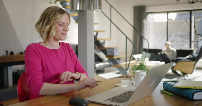 Attractive Woman rolling up her shirt sleeves and start typing on Computer