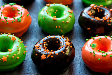 donuts in a glaze mix on a graphite stand