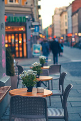 Fototapeta na wymiar Tables of outdoor street cafe in Oslo, Norway