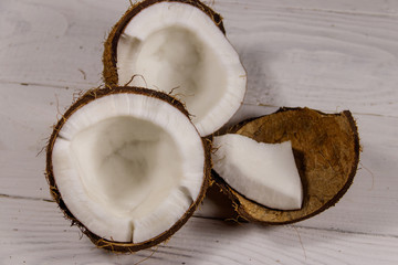 Fototapeta na wymiar Fresh ripe coconut on white wooden table