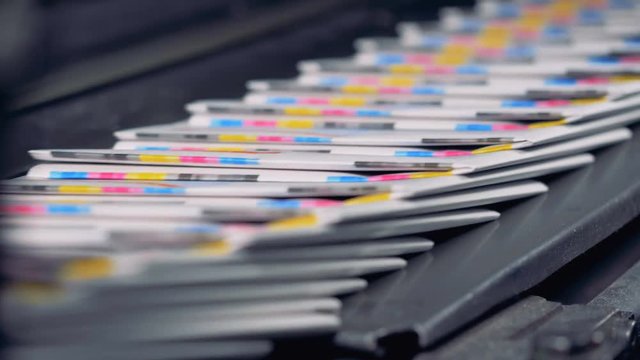 A big amount of ready-made newspapers on a printing house conveyor.
