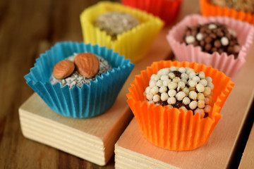 Set of sweets made of dried fruits with different sprinkles. East dessert