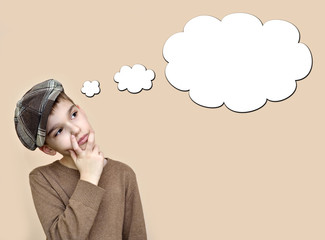 Thoughtful young boy wearing cap with an empty thought bubble