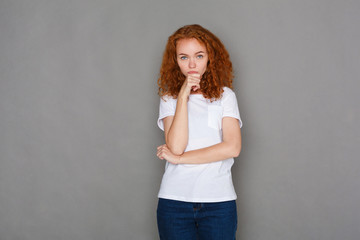 Pensive redhead young woman, studio shot