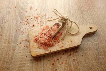 Pink himalayan salt on wooden background