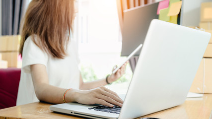 Young asian girl is freelancer with her private business at home office, working with laptop, coffee, online marketing, Customer order and packaging or packing.